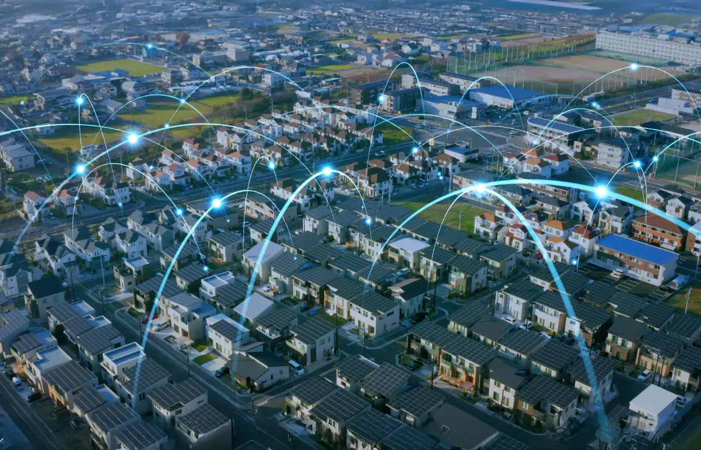 Illustration d'un quartier avec des maisons équipées de panneaux solaires et des flux lumineux représentant le partage d'énergie dans une communauté énergétique.